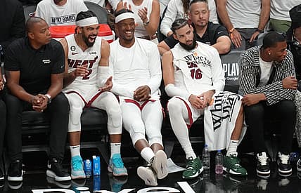 May 21, 2023; Miami, Florida, USA; Miami Heat guard Gabe Vincent (2), forward Jimmy Butler (22) and forward Caleb Martin (16) on the bench during the second half against the Boston Celtics in game three of the Eastern Conference Finals for the 2023 NBA playoffs at Kaseya Center. Mandatory Credit: Jim Rassol-USA TODAY Sports