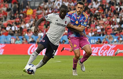 Jul 8, 2023; Toronto, Ontario, CAN;   St. Louis City forward Sam Adeniran (16) tries to dribble the ball past Toronto FC defender Shane O'Neill (27) in the first half at BMO Field. Mandatory Credit: Dan Hamilton-USA TODAY Sports
