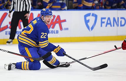 Apr 8, 2023; Buffalo, New York, USA;  Buffalo Sabres right wing Jack Quinn (22) makes a pass as he falls during the second period against the Carolina Hurricanes at KeyBank Center. Mandatory Credit: Timothy T. Ludwig-USA TODAY Sports