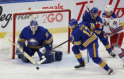 Apr 3, 2021; Buffalo, New York, USA;  Buffalo Sabres goaltender Linus Ullmark (35) makes a save as center Tobias Rieder (13) moves to clear the puck against the New York Rangers during the second period at KeyBank Center. Mandatory Credit: Timothy T. Ludwig-USA TODAY Sports