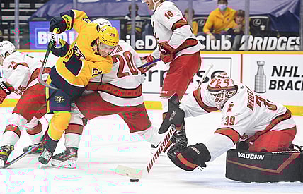 May 8, 2021; Nashville, Tennessee, USA; Nashville Predators right wing Eeli Tolvanen (28) tries to get around Carolina Hurricanes right wing Sebastian Aho (20) before the puck is covered by Carolina Hurricanes goaltender Alex Nedeljkovic (39) during the first period at Bridgestone Arena. Mandatory Credit: Christopher Hanewinckel-USA TODAY Sports