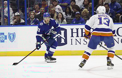 Nov 15, 2021; Tampa, Florida, USA; Tampa Bay Lightning center Brayden Point (21) skate with the puck as New York Islanders center Mathew Barzal (13) defends during the first period at Amalie Arena. Mandatory Credit: Kim Klement-USA TODAY Sports