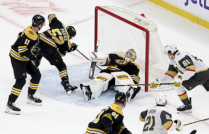 Vegas Golden Knights right wing Mark Stone (61) scores as Boston Bruins goaltender Jeremy Swayman (1) falls on top of the puck inside the net during the second period of an NHL hockey game, Saturday, Feb. 8, 2025, in Boston. (AP Photo/Mark Stockwell)