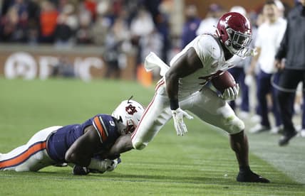 Nov 27, 2021; Auburn, Alabama, USA;  Auburn Tigers  linebacker Zakoby McClain (9) brings down Alabama Crimson Tide running back Brian Robinson Jr. (4) at Jordan-Hare Stadium. Alabama defeated Auburn in four overtimes. Mandatory Credit: Gary Cosby Jr.-USA TODAY Sports