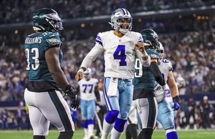 Sep 27, 2021; Arlington, Texas, USA;  Dallas Cowboys quarterback Dak Prescott (4) celebrates a touchdown  during the fourth quarter as Philadelphia Eagles defensive tackle Milton Williams (93) looks on at AT&T Stadium. Mandatory Credit: Kevin Jairaj-USA TODAY Sports