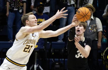 Dec 31, 2022; Berkeley, California, USA; California Golden Bears forward Lars Thiemann (21) and Colorado Buffaloes center Lawson Lovering (34) battle for a loose ball during the first half at Haas Pavilion. Mandatory Credit: D. Ross Cameron-USA TODAY Sports