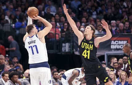 Mar 7, 2023; Dallas, Texas, USA;  Dallas Mavericks guard Luka Doncic (77) shoots over Utah Jazz forward Kelly Olynyk (41) during the second quarter at American Airlines Center. Mandatory Credit: Kevin Jairaj-USA TODAY Sports