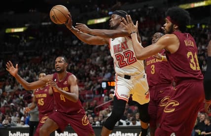 Mar 10, 2023; Miami, Florida, USA;  Miami Heat forward Jimmy Butler (22) passes the ball as Cleveland Cavaliers center Jarrett Allen (31) defends during the first half at Miami-Dade Arena. Mandatory Credit: Jim Rassol-USA TODAY Sports