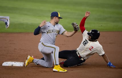 Aug 18, 2023; Arlington, Texas, USA; Texas Rangers second baseman Marcus Semien (2) slides under the tag  of Milwaukee Brewers shortstop Willy Adames (27) as he steals second base during the first inning at Globe Life Field. Mandatory Credit: Jerome Miron-USA TODAY Sports