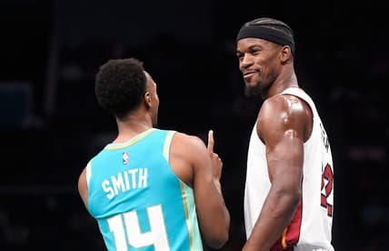 Nov 14, 2023; Charlotte, North Carolina, USA;  Miami Heat forward Jimmy Butler (22) talks to Charlotte Hornets guard Ish Smith (14) during a time out during the first half at the Spectrum Center. Mandatory Credit: Sam Sharpe-USA TODAY Sports