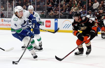 Mar 3, 2024; Anaheim, California, USA; Vancouver Canucks right wing Brock Boeser (6) shoots against Anaheim Ducks defenseman Gustav Lindstrom (28) during the first period at Honda Center. Mandatory Credit: Jason Parkhurst-USA TODAY Sports