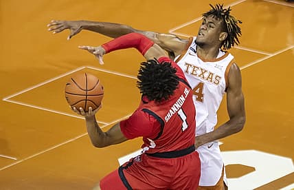 Jan 13, 2021, Austin, Texas, USA; Texas Tech Red Raiders guard Terrence Shannon Jr. (1) drives against Texas Longhorns forward Greg Brown (4) in the first half of an NCAA college basketball game on Wednesday, Jan. 13, 2021, in Austin, Texas.  Mandatory credit: Ricardo B. Brazziell /American-Statesman via USA TODAY Network