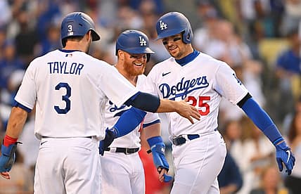 Jul 4, 2022; Los Angeles, California, USA; Los Angeles Dodgers right fielder Trayce Thompson (25) is met at the plate by left fielder Chris Taylor (3) and designated hitter Justin Turner (10) after hitting a three-run home run in the fifth inning against the Colorado Rockies at Dodger Stadium. Mandatory Credit: Jayne Kamin-Oncea-USA TODAY Sports