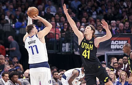 Mar 7, 2023; Dallas, Texas, USA;  Dallas Mavericks guard Luka Doncic (77) shoots over Utah Jazz forward Kelly Olynyk (41) during the second quarter at American Airlines Center. Mandatory Credit: Kevin Jairaj-USA TODAY Sports