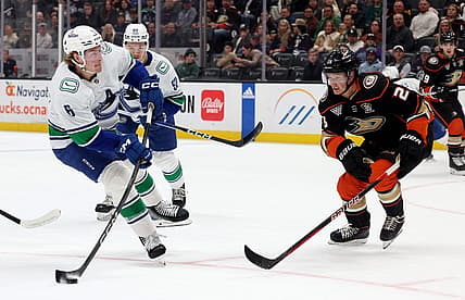 Mar 3, 2024; Anaheim, California, USA; Vancouver Canucks right wing Brock Boeser (6) shoots against Anaheim Ducks defenseman Gustav Lindstrom (28) during the first period at Honda Center. Mandatory Credit: Jason Parkhurst-USA TODAY Sports