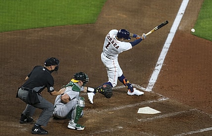 Apr 8, 2021; Houston, Texas, USA; Houston Astros shortstop Carlos Correa (1) hits an RBI double against the Oakland Athletics during the fourth inning at Minute Maid Park. Mandatory Credit: Thomas Shea-USA TODAY Sports