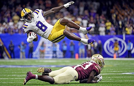 Sep 4, 2022; New Orleans, Louisiana, USA; Louisiana State Tigers wide receiver Malik Nabers (8) goes airborne as he is tackled by Florida State Seminoles defensive back Omarion Cooper (13) during the second half at Caesars Superdome. Mandatory Credit: Melina Myers-USA TODAY Sports