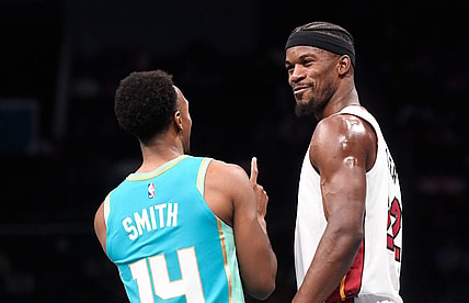 Nov 14, 2023; Charlotte, North Carolina, USA;  Miami Heat forward Jimmy Butler (22) talks to Charlotte Hornets guard Ish Smith (14) during a time out during the first half at the Spectrum Center. Mandatory Credit: Sam Sharpe-USA TODAY Sports