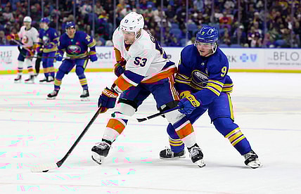 Mar 14, 2024; Buffalo, New York, USA;  New York Islanders center Casey Cizikas (53) controls the puck as Buffalo Sabres left wing Zach Benson (9) defends during the second period at KeyBank Center. Mandatory Credit: Timothy T. Ludwig-USA TODAY Sports