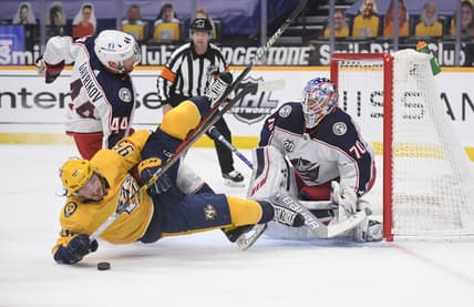 Feb 27, 2021; Nashville, Tennessee, USA;  Columbus Blue Jackets goaltender Joonas Korpisalo (70) blocks a shot by Nashville Predators center Matt Duchene (95) during the first period at Bridgestone Arena. Mandatory Credit: Steve Roberts-USA TODAY Sports