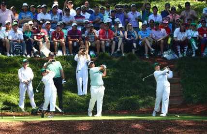 Apr 10, 2019; Augusta, GA, USA; Kiradech Aphibarnrat of Thailand (center) hits his tee shot with two guests during the Par 3 Contest at Augusta National Golf Club. Mandatory Credit: Rob Schumacher-USA TODAY Sports