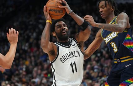 Feb 6, 2022; Denver, Colorado, USA; Brooklyn Nets guard Kyrie Irving (11) drives at Denver Nuggets guard Bones Hyland (3) in the second half at Ball Arena. Mandatory Credit: Ron Chenoy-USA TODAY Sports