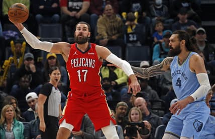 Mar 8, 2022; Memphis, Tennessee, USA; New Orleans Pelicans center Jonas Valanciunas (17) catches a pass as Memphis Grizzlies center Steven Adams (4) defends during the first half at FedExForum. Mandatory Credit: Petre Thomas-USA TODAY Sports