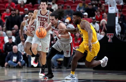 Jan 25, 2023; Lubbock, Texas, USA;  Texas Tech Red Raiders guard Pop Isaacs (2) dribbles against West Virgina Mountaineers guard Seth Wilson (14) in the first half at United Supermarkets Arena. Mandatory Credit: Michael C. Johnson-USA TODAY Sports