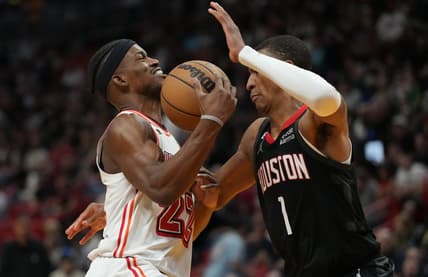 Feb 10, 2023; Miami, Florida, USA; Miami Heat forward Jimmy Butler (22) gets fouled by Houston Rockets forward Jabari Smith Jr. (1) in the first half at Miami-Dade Arena. Mandatory Credit: Jim Rassol-USA TODAY Sports