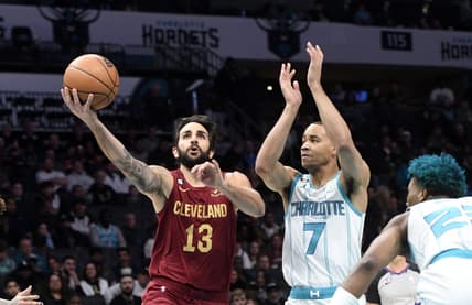 Mar 14, 2023; Charlotte, North Carolina, USA; Cleveland Cavaliers guard Ricky Rubio (13) drives past Charlotte Hornets guard Bryce McGowens (7) during the first half at the Spectrum Center. Mandatory Credit: Sam Sharpe-USA TODAY Sports