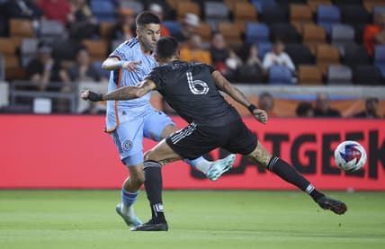 Mar 25, 2023; Houston, Texas, USA; New York City FC midfielder Gabriel Pereira (11) kicks the ball past Houston Dynamo midfielder Artur (6) during the first half at Shell Energy Stadium. Mandatory Credit: Troy Taormina-USA TODAY Sports