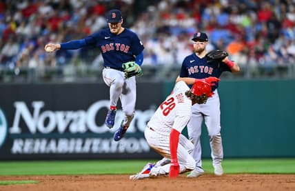 May 6, 2023; Philadelphia, Pennsylvania, USA; Boston Red Sox shortstop Kike Hernandez (5) leaps over Philadelphia Phillies infielder Alec Bohm (28) in the sixth inning at Citizens Bank Park. Mandatory Credit: Kyle Ross-USA TODAY Sports