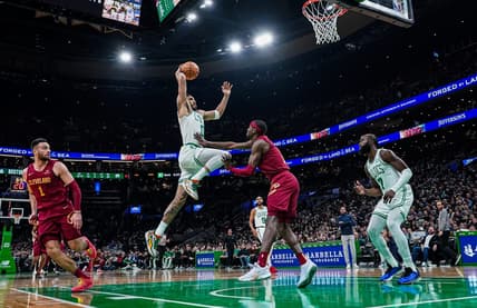 Dec 14, 2023; Boston, Massachusetts, USA; Boston Celtics forward Jayson Tatum (0) drives to the basket against Cleveland Cavaliers guard Caris LeVert (3) in the second half at TD Garden. Mandatory Credit: David Butler II-USA TODAY Sports