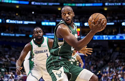 Dec 23, 2021; Dallas, Texas, USA;   Milwaukee Bucks forward Khris Middleton (22) controls the ball as  Dallas Mavericks small forward Theo Pinson (1) defends during the first half at American Airlines Center. Mandatory Credit: Kevin Jairaj-USA TODAY Sports