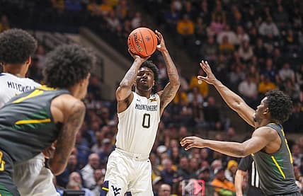 Jan 11, 2023; Morgantown, West Virginia, USA; West Virginia Mountaineers guard Kedrian Johnson (0) shoots a three pointer during the second half against the Baylor Bears at WVU Coliseum. Mandatory Credit: Ben Queen-USA TODAY Sports