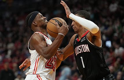 Feb 10, 2023; Miami, Florida, USA; Miami Heat forward Jimmy Butler (22) gets fouled by Houston Rockets forward Jabari Smith Jr. (1) in the first half at Miami-Dade Arena. Mandatory Credit: Jim Rassol-USA TODAY Sports