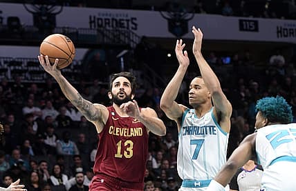 Mar 14, 2023; Charlotte, North Carolina, USA; Cleveland Cavaliers guard Ricky Rubio (13) drives past Charlotte Hornets guard Bryce McGowens (7) during the first half at the Spectrum Center. Mandatory Credit: Sam Sharpe-USA TODAY Sports