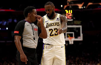 Mar 16, 2024; Los Angeles, California, USA; Los Angeles Lakers forward LeBron James (23) talks to referee Mitchell Ervin (27) during the second quarter against the Golden State Warriors at Crypto.com Arena. Mandatory Credit: Jason Parkhurst-USA TODAY Sports