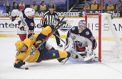 Feb 27, 2021; Nashville, Tennessee, USA;  Columbus Blue Jackets goaltender Joonas Korpisalo (70) blocks a shot by Nashville Predators center Matt Duchene (95) during the first period at Bridgestone Arena. Mandatory Credit: Steve Roberts-USA TODAY Sports