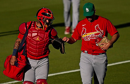 Mar 17, 2021; West Palm Beach, Florida, USA; St. Louis Cardinals catcher Yadier Molina (4) fist bumps starting pitcher Adam Wainwright (50) prior to the spring training game against the Houston Astros at The Ballpark of the Palm Beaches. Mandatory Credit: Jasen Vinlove-USA TODAY Sports