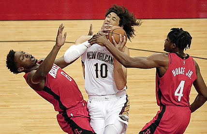 Apr 4, 2021; Houston, TX, USA;  New Orleans Pelicans center Jaxson Hayes (10) drives to basket past Houston Rockets forward Danuel House Jr. (4) as forward Jae'Sean Tate (8) is called for a block during the first quarter at Toyota Center.  Mandatory Credit: Bob Levey/Pool Photo-USA TODAY Sports