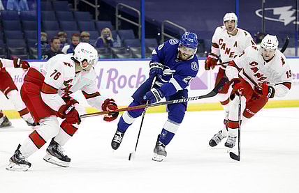 Apr 20, 2021; Tampa, Florida, USA; Tampa Bay Lightning center Blake Coleman (20) shoots as Carolina Hurricanes defenseman Brady Skjei (76) defends during the first period at Amalie Arena. Mandatory Credit: Kim Klement-USA TODAY Sports
