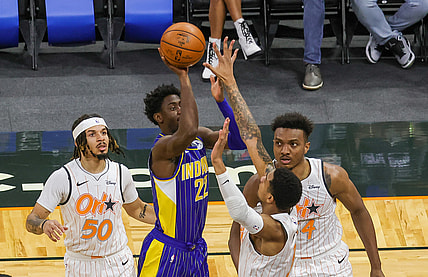 Apr 25, 2021; Orlando, Florida, USA; Indiana Pacers guard Caris LeVert (22) shoots the ball over Orlando Magic forward Chuma Okeke (3) and center Wendell Carter Jr. (34) as Orlando Magic guard Cole Anthony (50) looks on during the first quarter at Amway Center. Mandatory Credit: Mike Watters-USA TODAY Sports