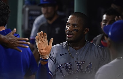 Aug 21, 2021; Boston, Massachusetts, USA;  Texas Rangers left fielder Andy Ibanez (77) is greeted in the dugout after scoring a run against the Boston Red Sox during the fourth inning at Fenway Park. Mandatory Credit: Bob DeChiara-USA TODAY Sports