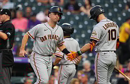 Sep 7, 2021; Denver, Colorado, USA; San Francisco Giants catcher Buster Posey (28) celebrates scoring a run with third baseman Evan Longoria (10) in the first inning against the Colorado Rockies at Coors Field. Mandatory Credit: Ron Chenoy-USA TODAY Sports