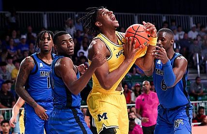 Nov 22, 2023; Paradise Island, BAHAMAS;  Michigan Wolverines forward Tarris Reed Jr. (32) controls the ball as Memphis Tigers guard Jayhlon Young (1) and Memphis Tigers forward David Jones (8) defend during the first half at Imperial Arena. Mandatory Credit: Kevin Jairaj-USA TODAY Sports