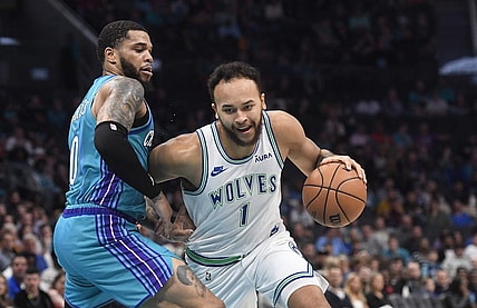 Dec 2, 2023; Charlotte, North Carolina, USA;  Minnesota Timberwolves forward Kyle Anderson (1) drives past Charlotte Hornets forward Miles Bridges (0) during the first half at the Spectrum Center. Mandatory Credit: Sam Sharpe-USA TODAY Sports