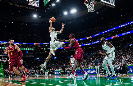 Dec 14, 2023; Boston, Massachusetts, USA; Boston Celtics forward Jayson Tatum (0) drives to the basket against Cleveland Cavaliers guard Caris LeVert (3) in the second half at TD Garden. Mandatory Credit: David Butler II-USA TODAY Sports