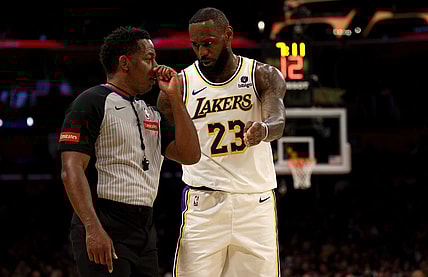 Mar 16, 2024; Los Angeles, California, USA; Los Angeles Lakers forward LeBron James (23) talks to referee Mitchell Ervin (27) during the second quarter against the Golden State Warriors at Crypto.com Arena. Mandatory Credit: Jason Parkhurst-USA TODAY Sports