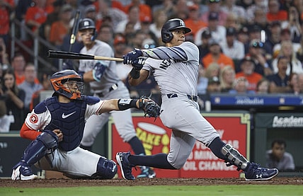 Mar 28, 2024; Houston, Texas, USA; New York Yankees right fielder Juan Soto (22) hits an RBI single during the fifth inning against the Houston Astros at Minute Maid Park. Mandatory Credit: Troy Taormina-USA TODAY Sports